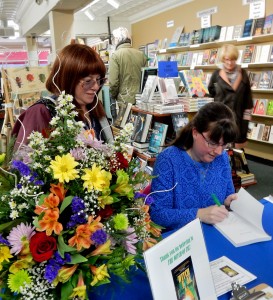 Author Kerry Gans signs a book for Ann Stolinski of Gemini Wordsmiths